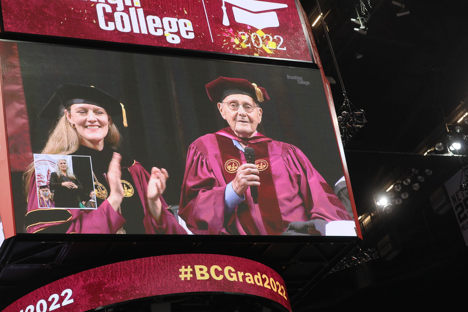 President Michelle J. Anderson and Distinguished Alumnus and Brooklyn College Foundation Trustee Leonard Tow ’50 appear on the jumbo screen at the 2022 Brooklyn College Commencement at Barclays Center.
