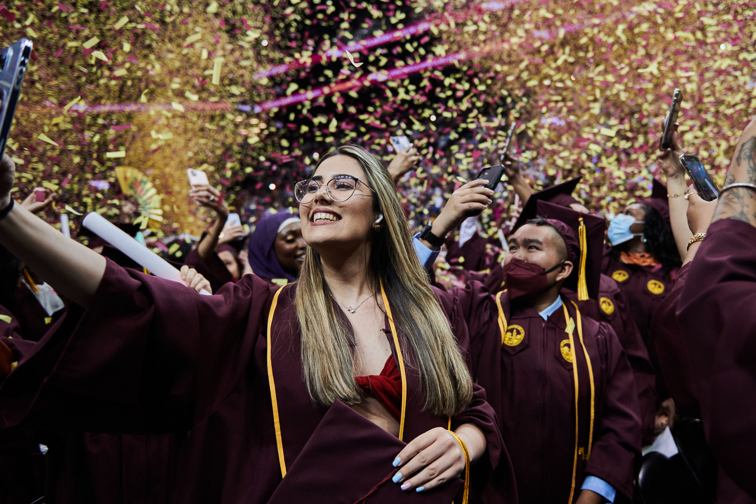 The confetti flies and graduates celebrate the 2022 Brooklyn College Commencement at Barclays Center.