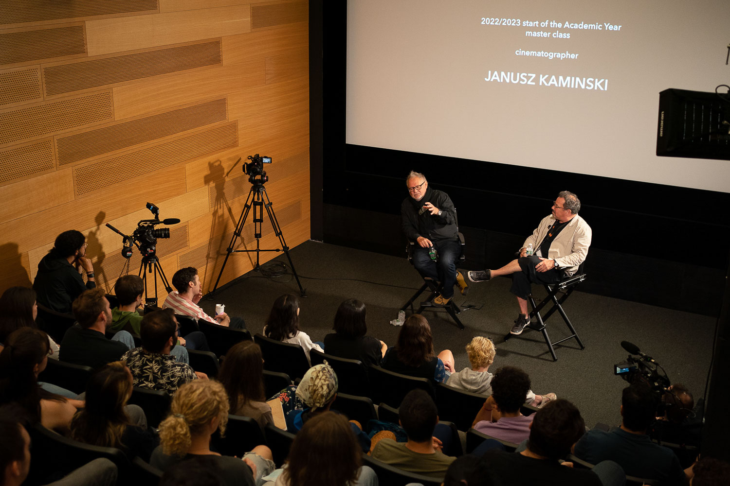 The director of the Feirstein Graduate School of Cinema Richard Gladstein (on stage, right) joins Cinematographer Janusz Kaminski at one of a series of master classes at the school.